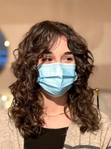 22 flattering ways to pair curtain bangs with curly hair