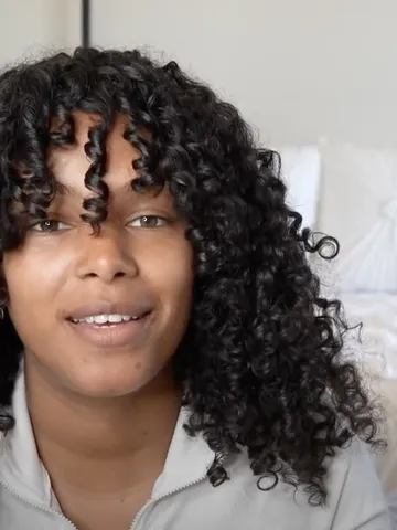 here s how to rock curtain bangs with curly hair