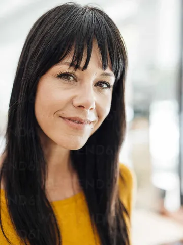 smiling mature woman with hair bangs stock photo