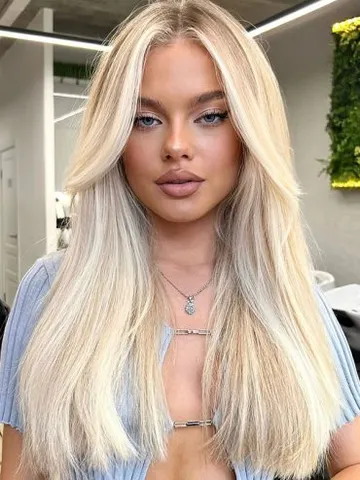 Icy Platinum Blonde with Long Straight Layers and Curtain Bangs