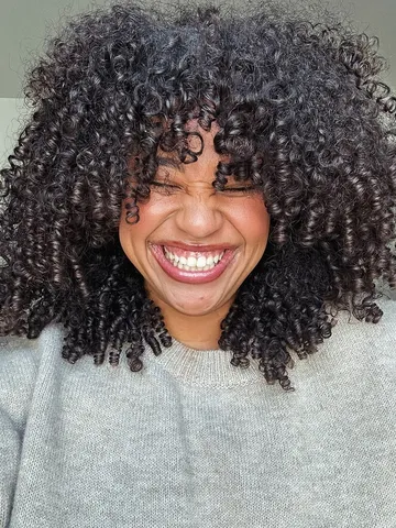 12 trending hairstyles with curly bangs to try asap