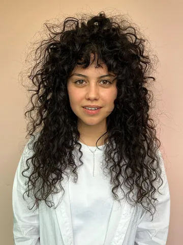 curly hair with bangs or a fringe cuts colouring products