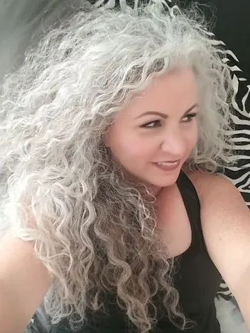 i love that i let my hair go natural the curl and the grey a