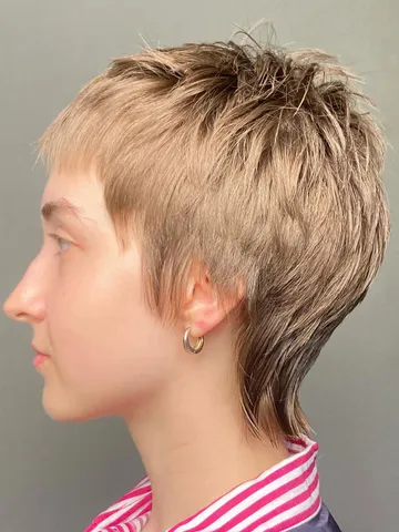 edgy blonde pixie mullet with choppy layers for a bold first