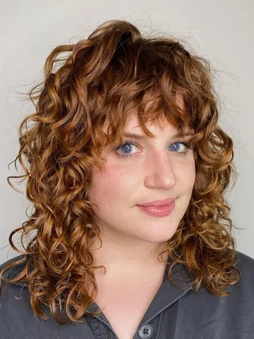 30 Stylish and Effortless Curly Hair With Bangs Hairstyles You’ll Love
