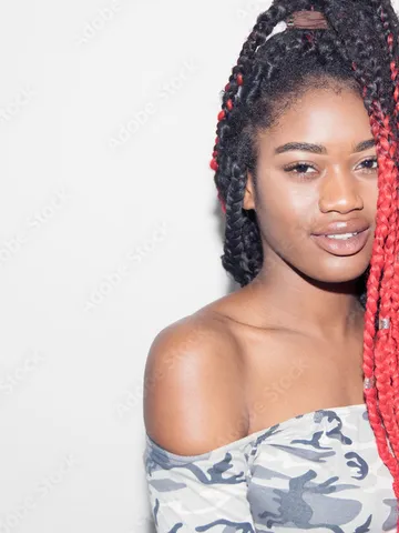 portrait confident young woman with long red braids stock ph