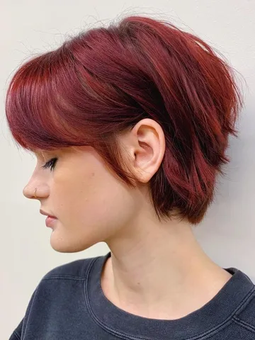 dark red bixie cut with middle part bangs longer pixie hairc